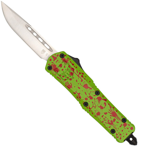 A pocket knife with a silver stainless steel blade and a bright lime green handle featuring a red splatter pattern, shown against a plain white background.