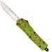 A pocket knife with a silver stainless steel blade and a bright lime green handle featuring a red splatter pattern, shown against a plain white background.