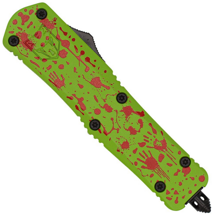 A tactical folding knife with a bright lime green handle decorated with red blood splatters and handprint motifs, shown against a plain white background.
