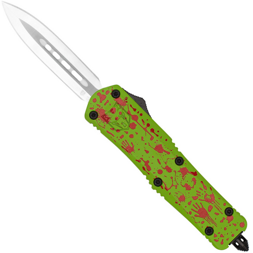 A pocket knife with a silver blade and a bright green handle decorated with red splatter and skull patterns, shown on a plain white background.